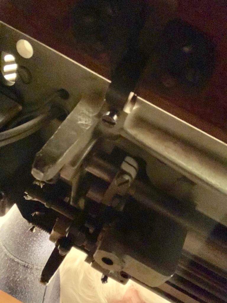 The underside of the sewing machine
